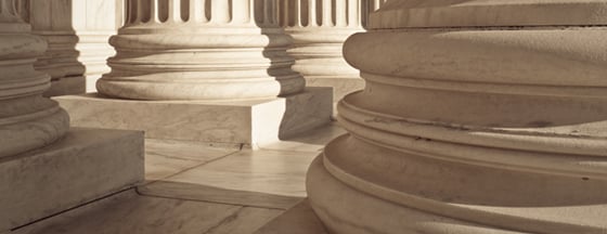 Image of the base of the large Corinthian columns at the entrance to the Supreme Court Building