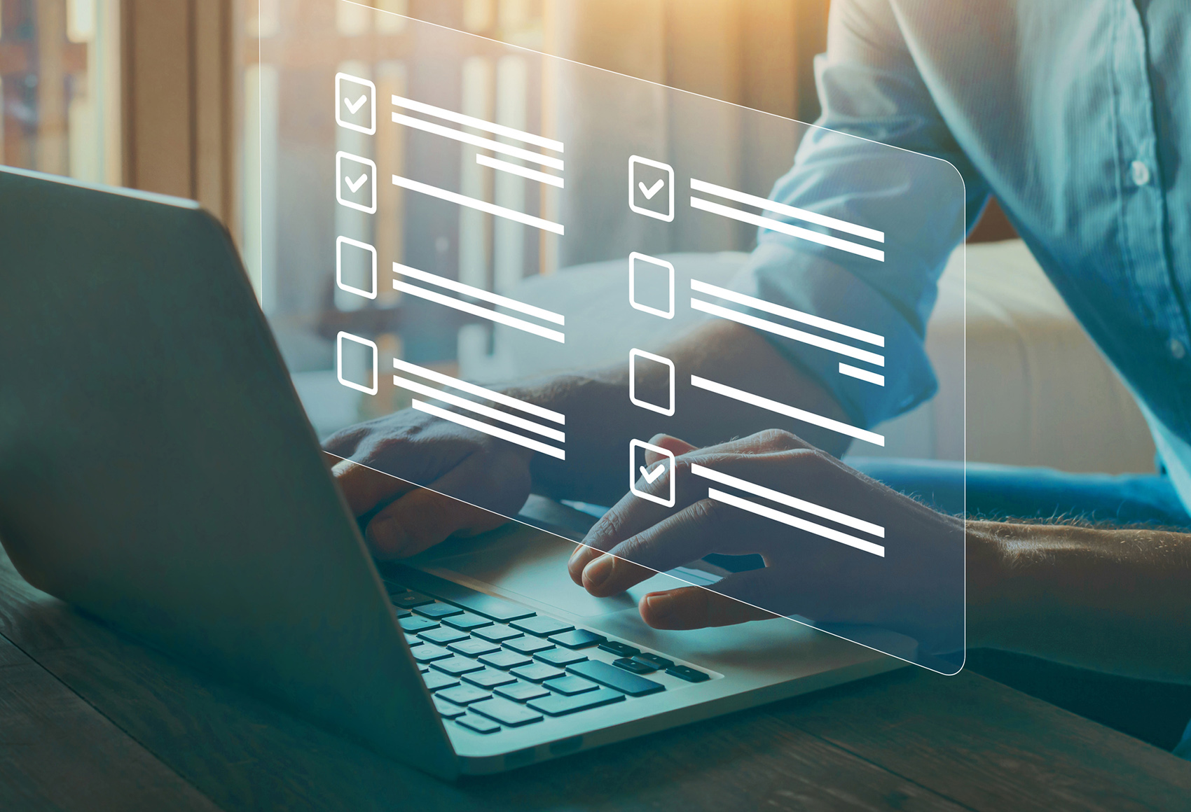 A mans hand resting on a laptop with an augmented display showing in front of him