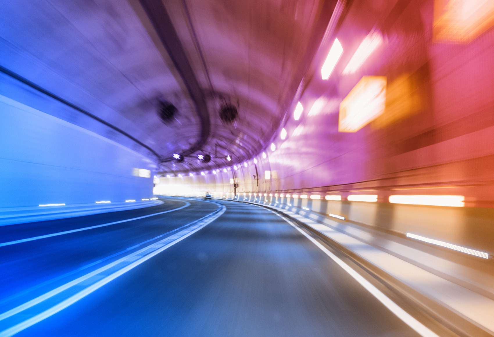 Convergence A blurred view POV shot of a car going through a curved tunnel