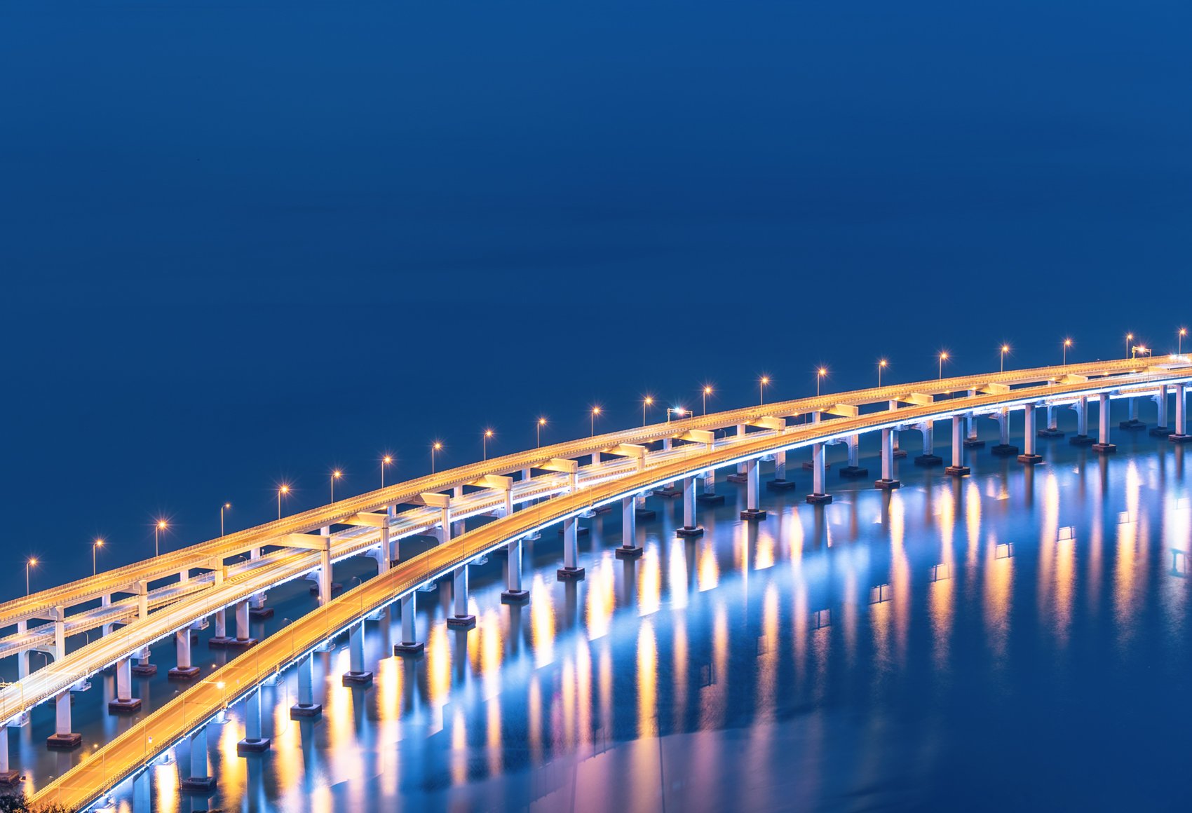 3 curved roads travelling across a body of water